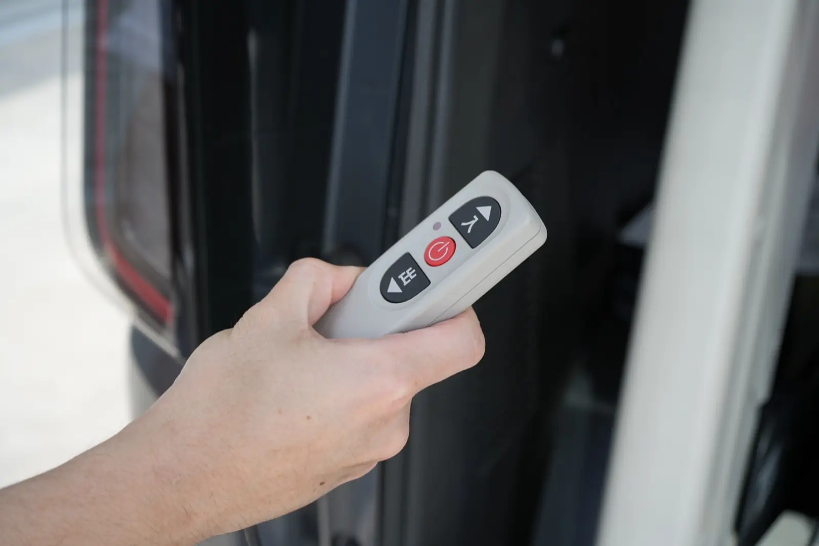 Hand-held remote that raises and lowers the ramp